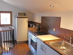 a kitchen with a sink and a refrigerator at Ferienwohnung Kohlstatt in Kiefersfelden