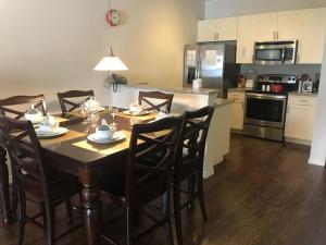 a kitchen with a table with chairs and a dining room at 3 Bedrooms 2 Bathrooms Lucaya Village 22-103 in Orlando