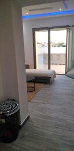 a room with a bed and a view of the ocean at Résidence Inès Djerba Appartements VIP in Houmt Souk
