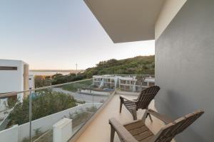two chairs on a balcony with a view of the ocean at Lagoa Views - Holiday Apartment by SCH in Foz do Arelho
