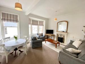 a living room with a couch and a table at Merrifield House in Sidmouth