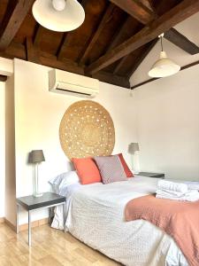 a bedroom with a large bed with two pillows at Apartamento Canónigo - terraza con vistas in Toledo