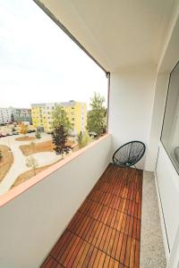 a balcony with a bench and a large window at Moderne ruhige 2-Zimmer Wohnung in Coswig in Coswig
