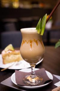 a drink in a glass on a table at Hotel Freud in Ostravice