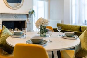 a dining room table with a vase of flowers on it at Coppergate Mews Grimsby No.1 - 2 bed, 2 bath, ground floor apartment in Grimsby +4 photos