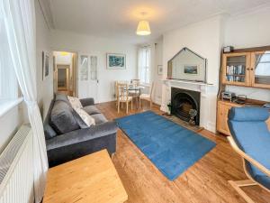 a living room with a couch and a fireplace at Petra 2-uk39884 in Marazion