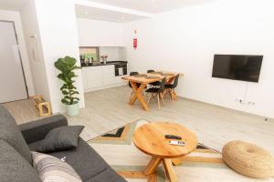 a living room with a couch and a table at Ericeira Surf Apartments in Ericeira