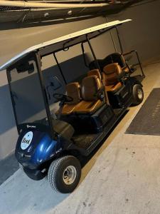 a golf cart with two seats in a building at Root Redrock Yalıkavak in Bodrum City