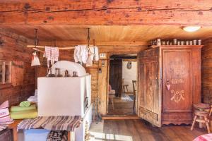 a kitchen with a white refrigerator and wooden walls at Stoffelhäusl in Reith im Alpbachtal