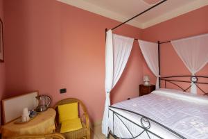 a bedroom with a canopy bed and a wooden table at Al Campanaro b&b in Taurasi +59 photos