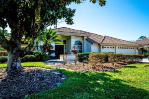 a house with a tree in the yard at Fairway Haven in Wesley Chapel