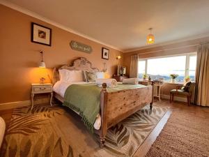 a bedroom with a large bed and a large window at Blue Anchor House - Seaview, Hot Tub Apartments in Blue Anchor