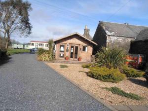 una pequeña casa con una entrada delante de ella en Castlewigg holiday park Whithorn 2 bed caravan, en Newton Stewart