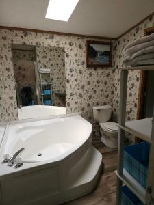 a bathroom with a tub and a toilet and a sink at Sharon's Run Cozy 3 bedroom/2 bath 