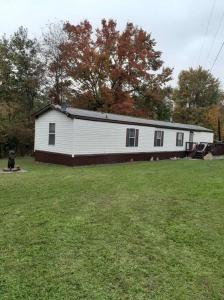 a large white building in the middle of a yard at Sharon's Run Cozy 3 bedroom/2 bath 
