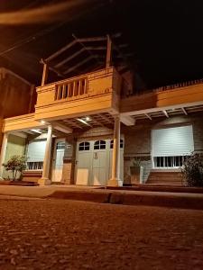 a building with a balcony on a street at night at La Casa del Paraná - San Pedro in San Pedro