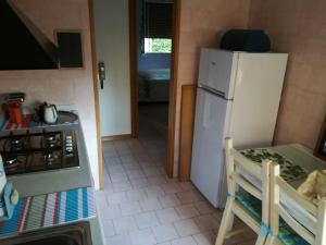 een keuken met een witte koelkast en een fornuis bij MicaMatti near Maranello in Castelnuovo Rangone