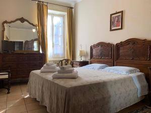 a bedroom with a large bed with towels on it at Albergo Dell'Angelo in Pieve di Teco