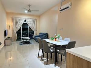 a kitchen and living room with a table and chairs at Twin Galaxy city view 2 Bedroom with balcony in Johor Bahru