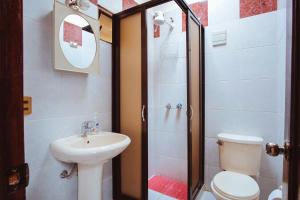 a bathroom with a sink and a toilet and a shower at La Maison Martinet in Uyuni