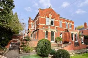 a large red brick building with a large window at Coppergate Mews Grimsby No.3 - 2 bed, 2 bath, ground floor apartment in Grimsby