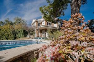 a large house with a swimming pool in front of it at Villa Elvira by MarCalma in Les tres Cales