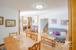 a living room with a couch and a table at Villa Elvira by MarCalma in Les tres Cales