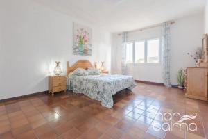 a bedroom with a bed and a dresser and a window at Villa Elvira by MarCalma in Les tres Cales +24 photos