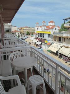 a balcony with a table and chairs and a view of a city at Hotel Lito in Paralia Katerinis