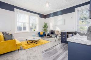 a living room with a yellow couch and a table at Coppergate Mews Grimsby No.4 - 1 bed, 1st floor apartment in Grimsby