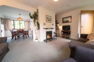 a living room with a table and a fireplace at Beck Yeat Cottage Coniston in Coniston