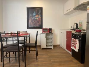 a kitchen with a table and chairs and a kitchen with a refrigerator at (21) Depto. nuevo y acogedor en Miraflores in Lima
