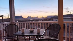 a table and chairs on a balcony with a view at Goulding's Lodge in Monument Valley