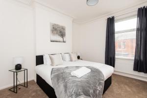 a bedroom with a large bed and a window at Bede House in Monkwearmouth