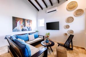 a living room with a couch and a tv at The Lodge at Jaguar Reef in Hopkins