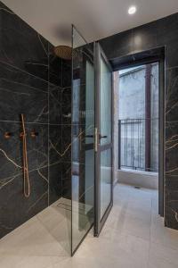 a bathroom with a glass shower with a glass door at Talbiye brand new luxury place in Jerusalem