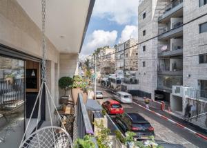 a balcony with cars parked on a city street at Talbiye brand new luxury place in Jerusalem