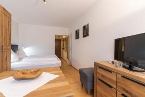 a room with two beds and a flat screen tv at Ferienwohnung M. Simbeck in Oberstdorf