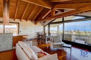 a living room with a couch and chairs and a table at Paradise Lake View in a 5 pools exclusive residence DesenzanoLoft Official Partner Homes & Villas by Marriott Bonvoy in Desenzano del Garda