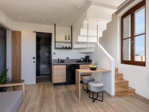 a kitchen with a counter and a table and chairs at Ethos Suites in Chania