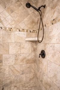 a shower with a shower head in a bathroom at The Capri at Siesta in Siesta Key