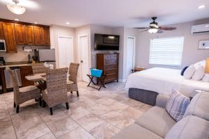 a bedroom with a bed and a table and a kitchen at The Capri at Siesta in Siesta Key