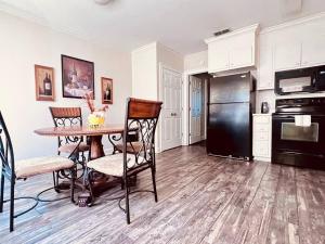 a kitchen with a table and a black refrigerator at Southern Comfort in Albany