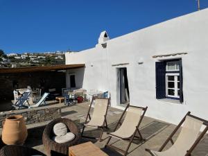 a group of chairs sitting on a patio at villa ZEUS - PARIKIA - PAROS - GRECE in Krotiri