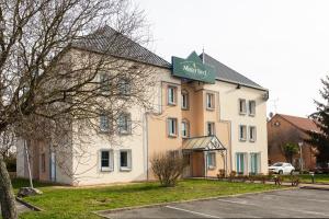 un bâtiment avec un panneau sur son côté dans l'établissement Mister Bed Saran, à Saran