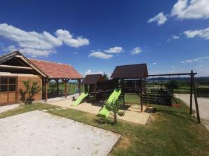 a playground with a slide and a pavilion at Lotti Residence Exclusiv in Balatonfüred