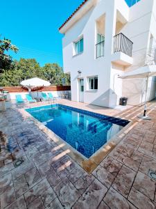 a swimming pool in front of a house at Villa Alkioni 31 in Paralimni