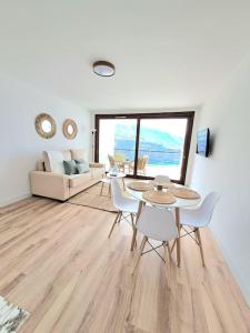 un soggiorno con tavolo, sedie e divano di Playa San Marcos Apt.Mirador del Roque a Icod de los Vinos