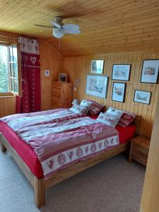 a bedroom with a large bed in a wooden room at Résidence « la Forêt » in Les Mosses