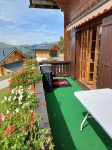 a balcony with green flooring on a house at Résidence « la Forêt » in Les Mosses